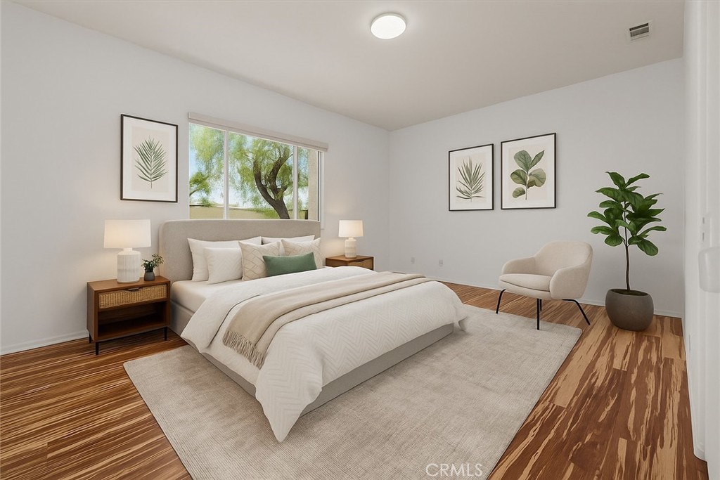 1706 Brittney Road Beaumont, CA 92223 - Photo 16 of 44 a bedroom with a bed and a potted plant on dresser