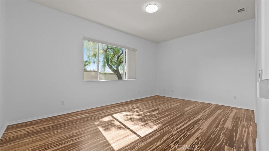 1706 Brittney Road Beaumont, CA 92223 - Photo 17 of 44 wooden floor in an empty room with a window