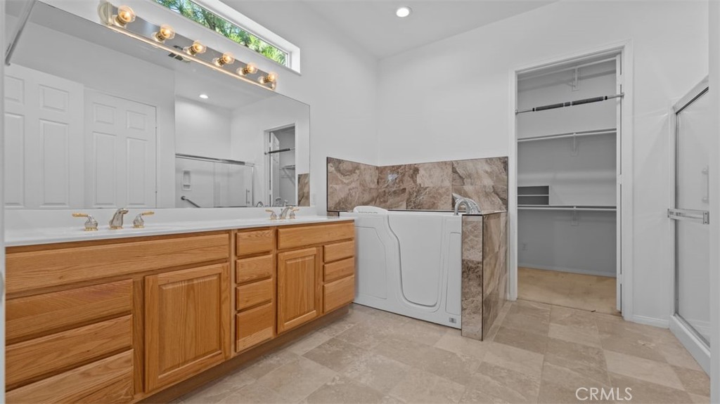 1706 Brittney Road Beaumont, CA 92223 - Photo 19 of 44 a spacious bathroom with a double vanity sink mirror and double