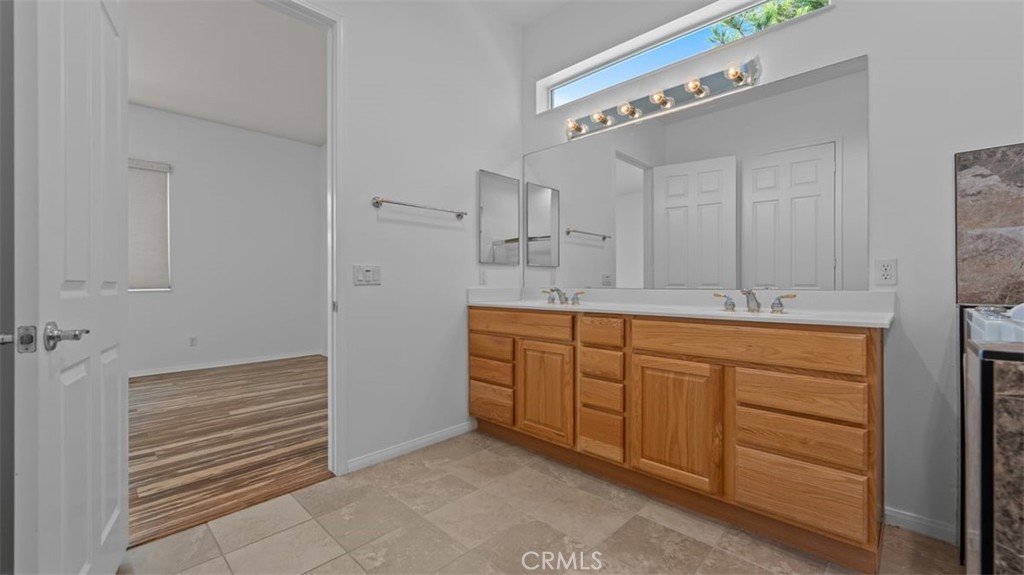 1706 Brittney Road Beaumont, CA 92223 - Photo 20 of 44 a bathroom with a sink a vanity and a mirror