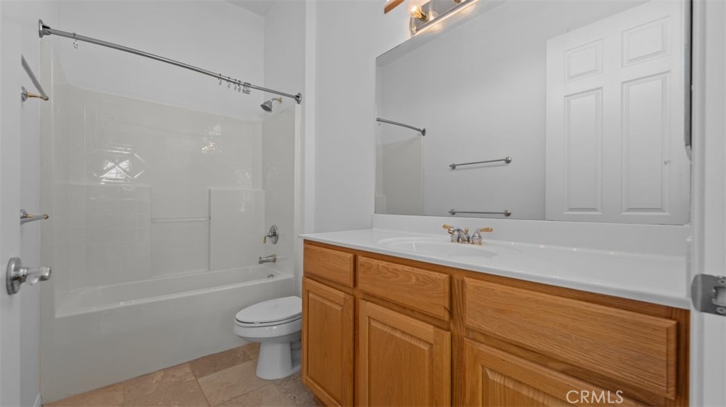 1706 Brittney Road Beaumont, CA 92223 - Photo 29 of 44 a bathroom with a granite countertop sink a toilet and shower