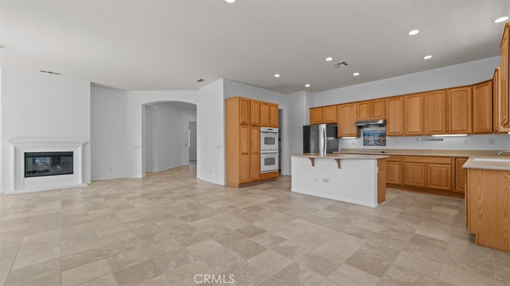1706 Brittney Road Beaumont, CA 92223 - Photo 10 of 44 a kitchen with stainless steel appliances a refrigerator sink and cabinets