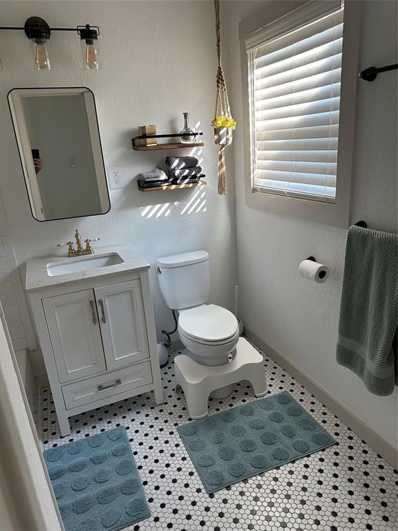 3204 North 24th Street Waco, TX 76708 - Photo 5 of 16 a bathroom with a sink toilet and window