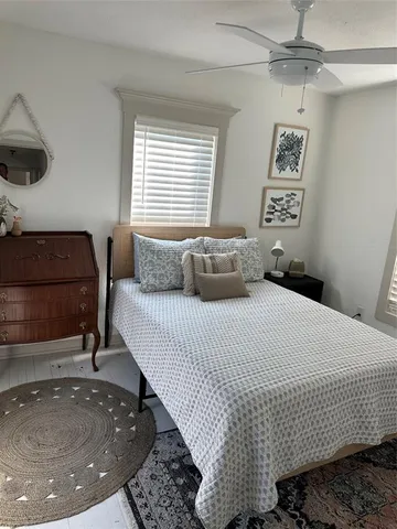 a bedroom with a bed and a night stand