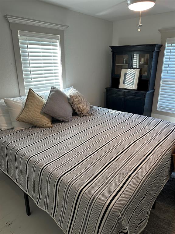 3204 North 24th Street Waco, TX 76708 - Photo 9 of 16 a bedroom with a large bed and a dresser