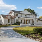 a view of a house with swimming pool and a yard