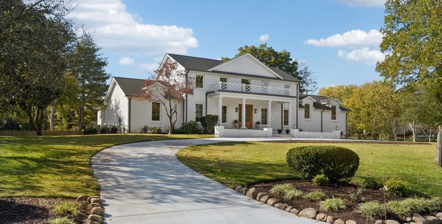a view of a house with swimming pool and a yard