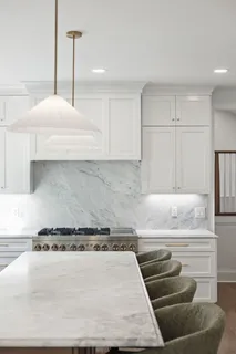 a bathroom with a granite countertop sink and a toilet