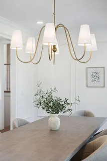 a bathroom with a sink a large mirror and a bathtub next to a window