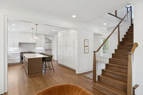 a bathroom with a granite countertop sink a toilet and a mirror