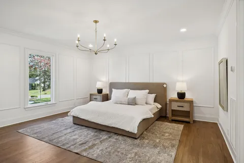 a house with a big yard and large trees