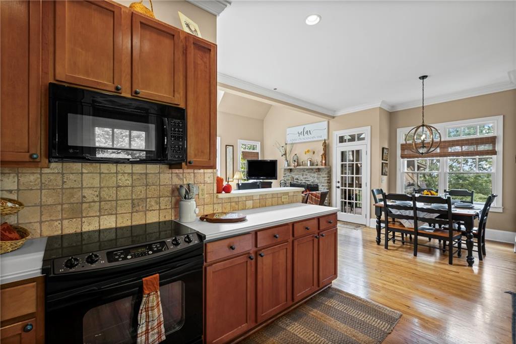 23 Laurel Ridge Trail Big Canoe, GA 30143 - Photo 12 of 36 a kitchen with stainless steel appliances a stove sink microwave and cabinets