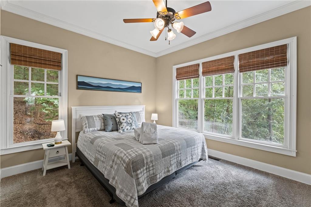 23 Laurel Ridge Trail Big Canoe, GA 30143 - Photo 14 of 36 a bedroom with a large bed and a window