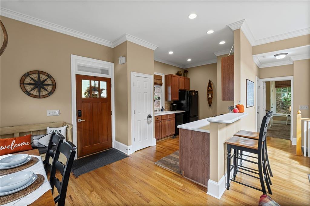 23 Laurel Ridge Trail Big Canoe, GA 30143 - Photo 6 of 36 a kitchen with stainless steel appliances granite countertop a refrigerator a stove a sink a dining table and chairs with wooden floor