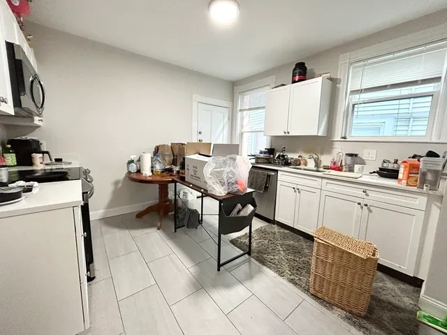 a kitchen with a sink cabinets and window