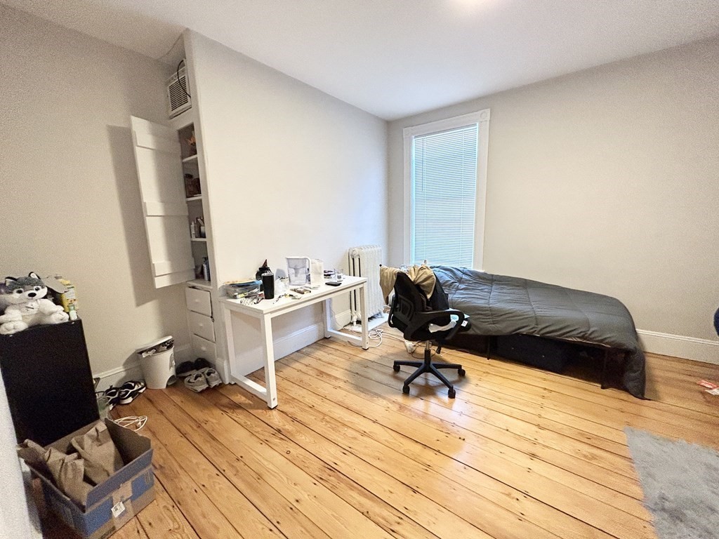 9 Mt Pleasant Avenue, Unit 2 Boston, MA 02119 - Photo 3 of 9 a workspace with furniture and wooden floor