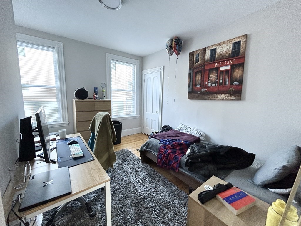 9 Mt Pleasant Avenue, Unit 2 Boston, MA 02119 - Photo 4 of 9 a living room with furniture and a flat screen tv