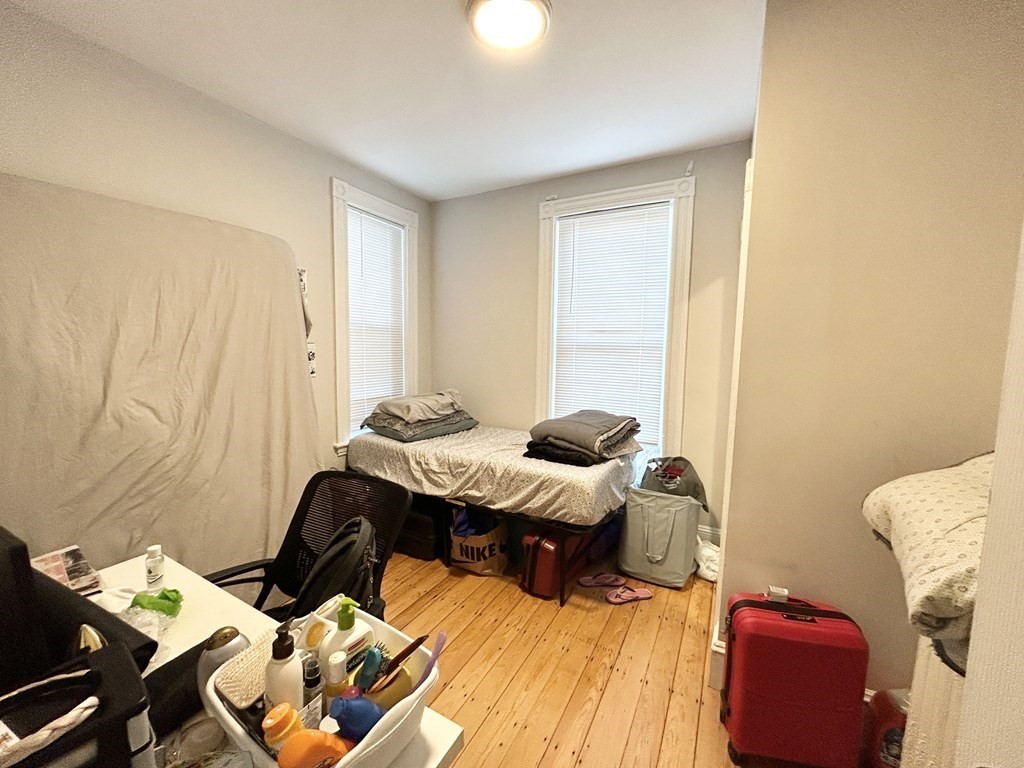 9 Mt Pleasant Avenue, Unit 2 Boston, MA 02119 - Photo 7 of 9 a bedroom with a bed and gym equipment