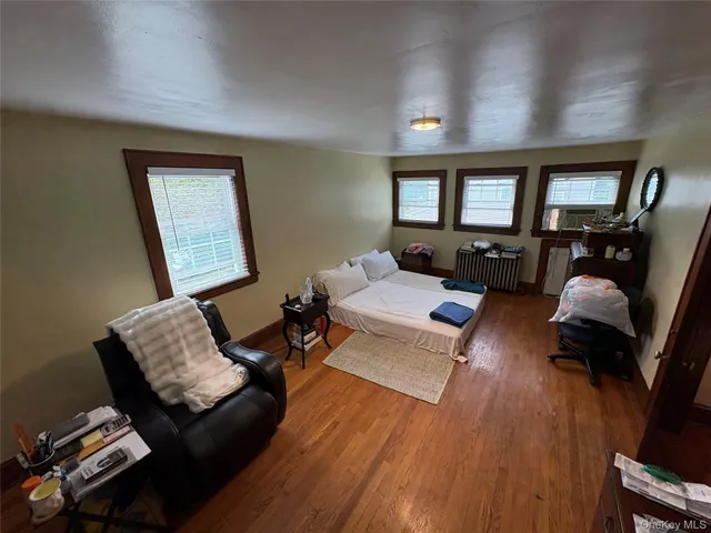 a living room with furniture and a flat screen tv with wooden floor