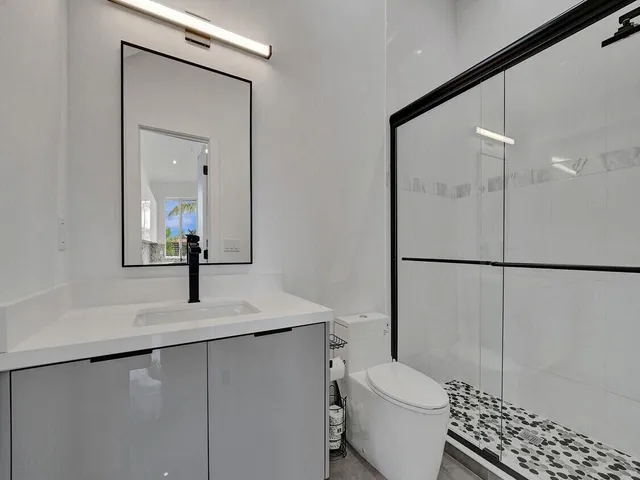 a bathroom with a sink toilet and shower