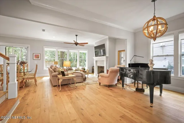 a living room with furniture a fireplace and a large window
