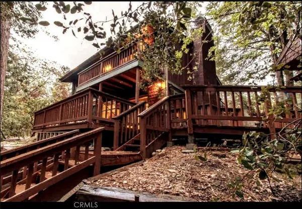 a view of a house with a wooden deck