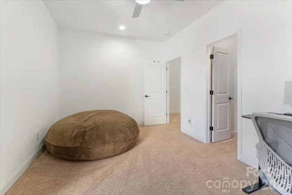 an empty room with a fireplace and wooden floor