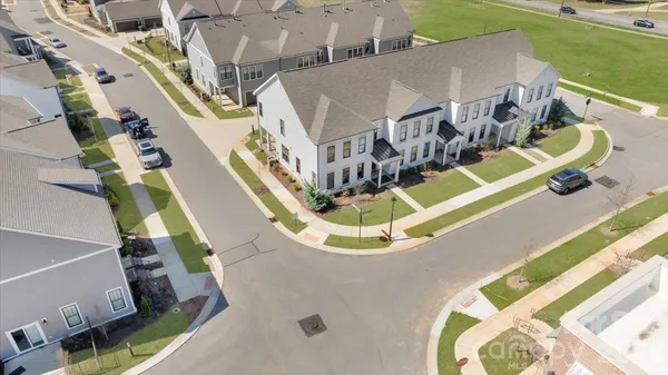 an aerial view of a house with a big yard