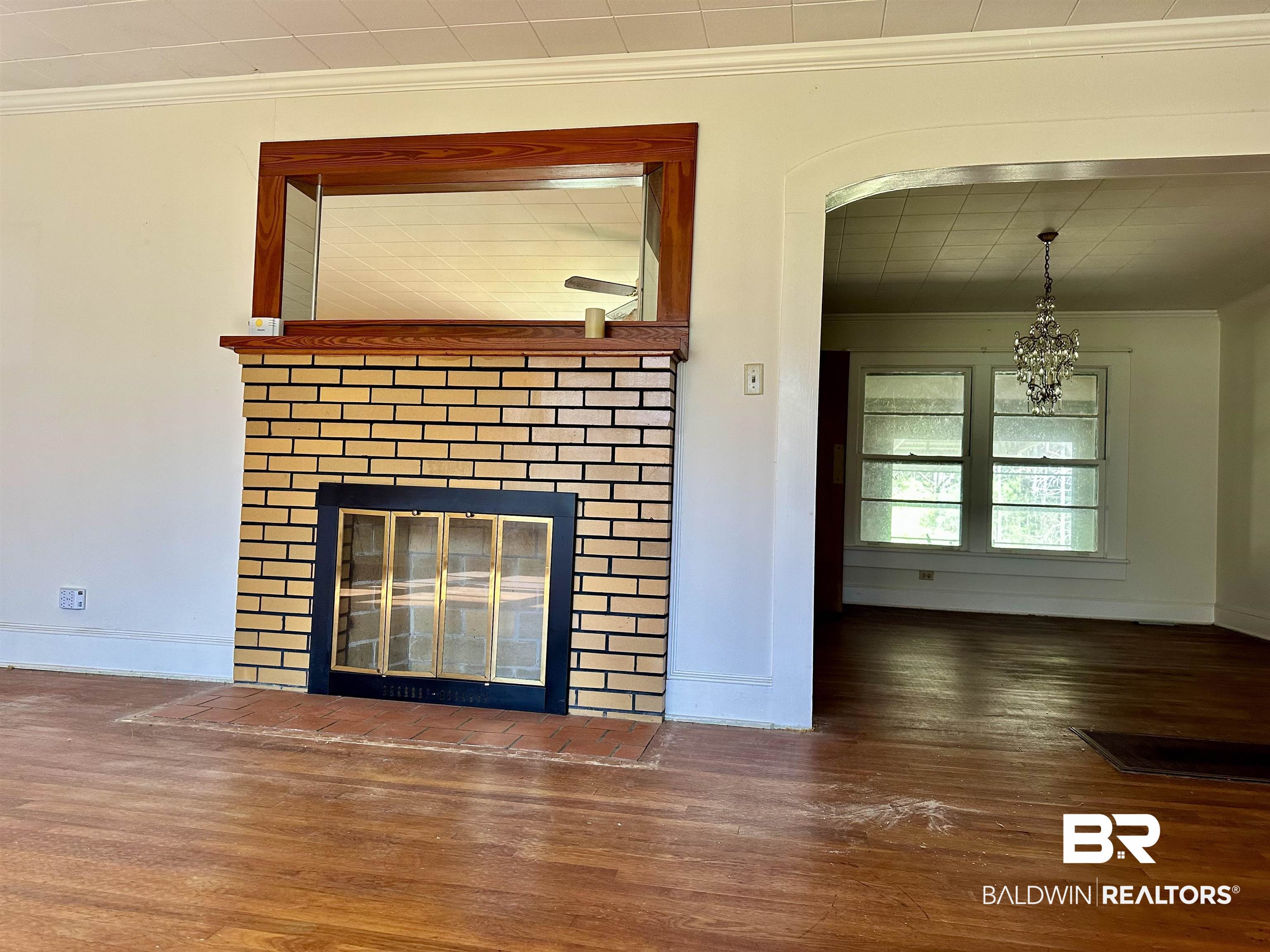 3556 Damascus Road Brewton, AL 36426 - Photo 11 of 17 Details with baseboards, wood finished floors, ornamental molding, and a fireplace