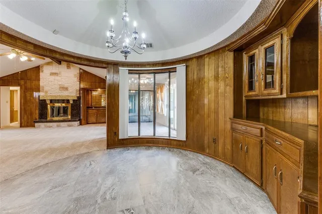 a view of an empty room with a kitchen