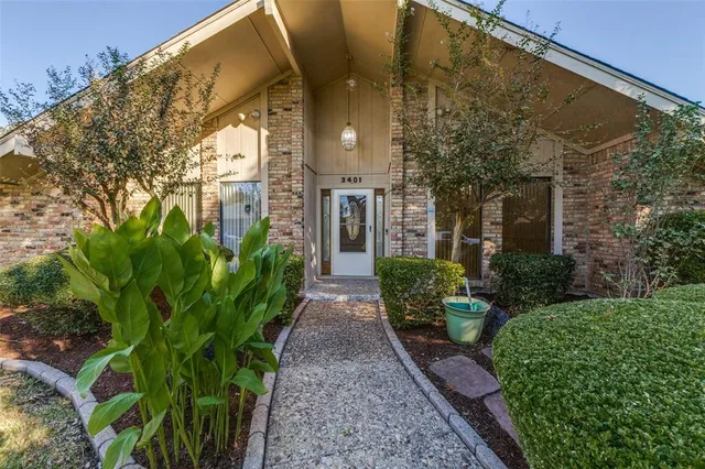 a view of a pathway with a garden
