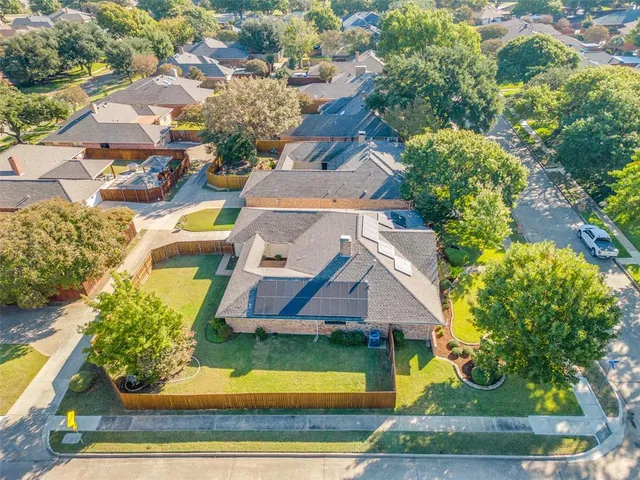 an aerial view of a house with a garden and plants