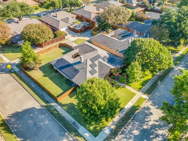 an aerial view of residential houses with yard