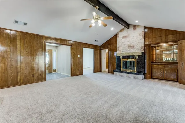 a view of an empty room with a kitchen