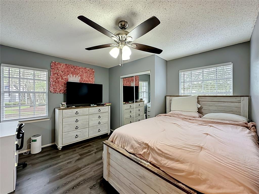 3705 Southwest 27th Street, Unit 922 Gainesville, FL 32608 - Photo 14 of 34 a bedroom with a bed flat screen tv and a window
