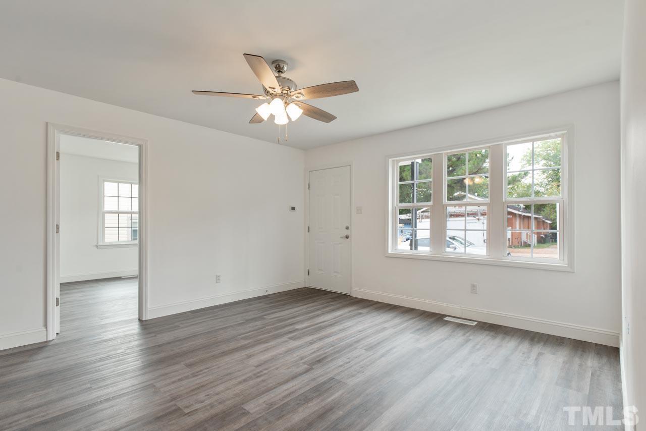 713 Quarry Street Raleigh, NC 27601 - Photo 14 of 26 a view of empty room with wooden floor and fan