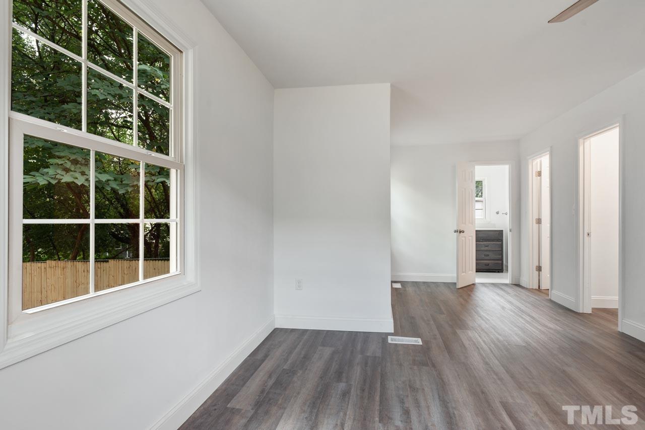 713 Quarry Street Raleigh, NC 27601 - Photo 16 of 26 a view of empty room with wooden floor and windows