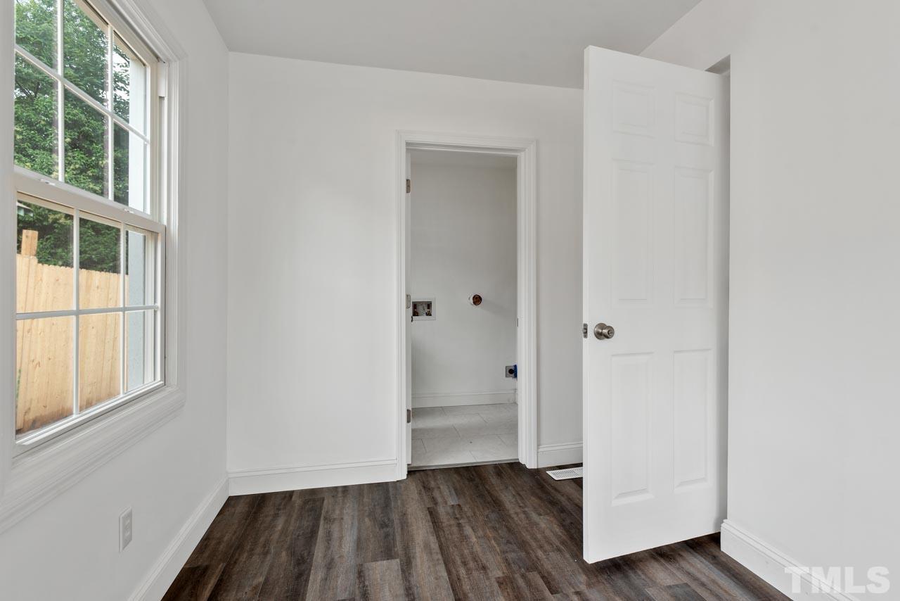 713 Quarry Street Raleigh, NC 27601 - Photo 22 of 26 a view of empty room with wooden floor and fan