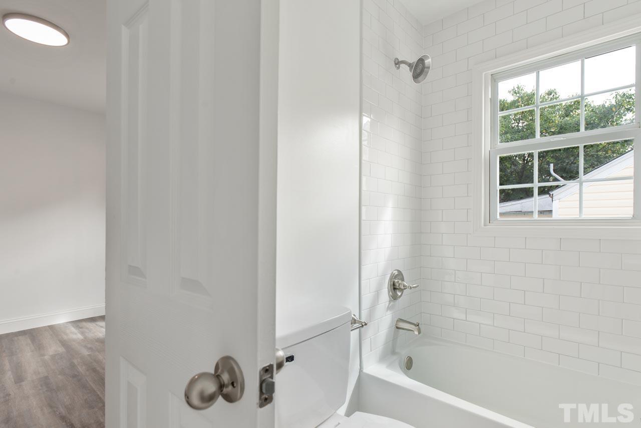 713 Quarry Street Raleigh, NC 27601 - Photo 9 of 26 a bathroom with a tub and shower