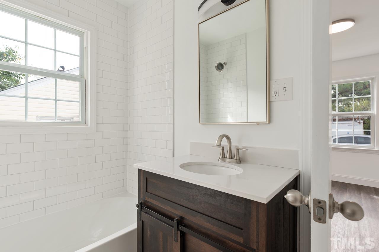 713 Quarry Street Raleigh, NC 27601 - Photo 10 of 26 a bathroom with a sink and a mirror