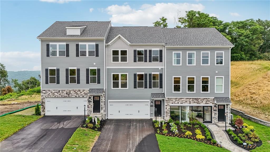 a aerial view of a brick house next to a yard