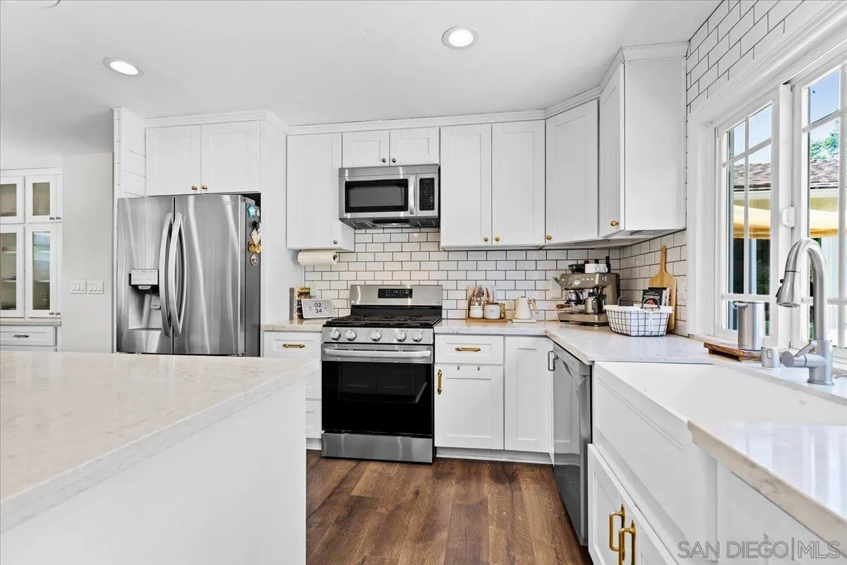 12243 Buckskin Trail Poway, CA 92064 - Photo 15 of 41 a kitchen with stainless steel appliances granite countertop a stove a sink and a refrigerator