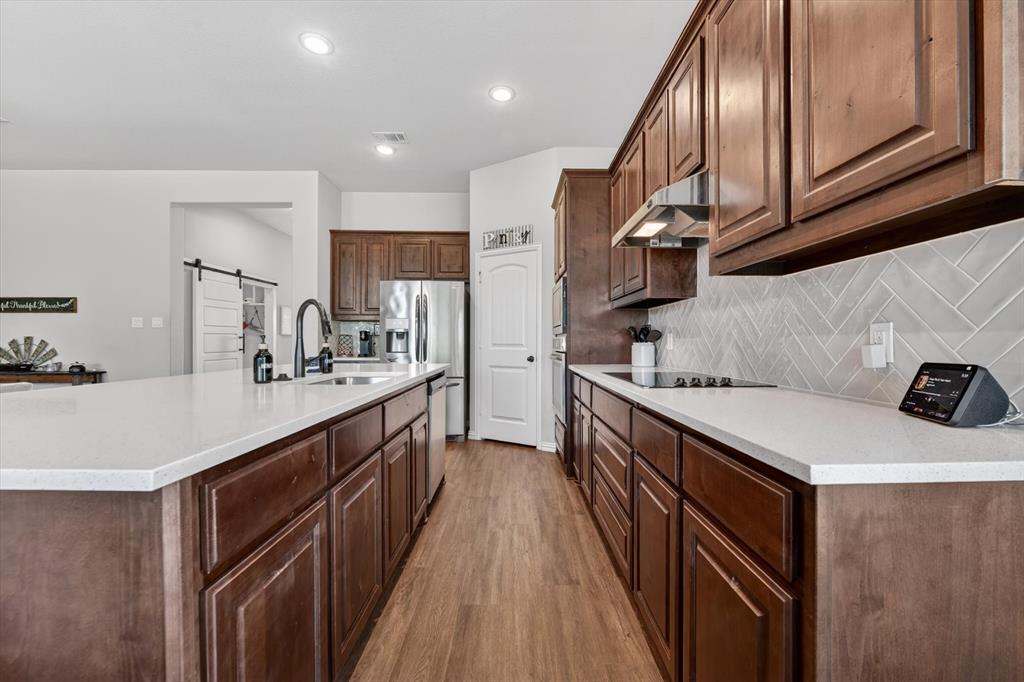 150 Chester Road Springtown, TX 76082 - Photo 11 of 40 a kitchen with a sink a stove and cabinets