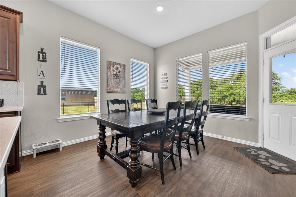 150 Chester Road Springtown, TX 76082 - Photo 13 of 40 a view of a dining room with furniture and wooden floor