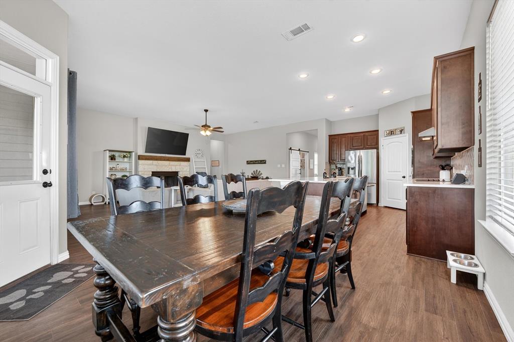 150 Chester Road Springtown, TX 76082 - Photo 14 of 40 a dining hall with stainless steel appliances granite countertop a table chairs and a living room
