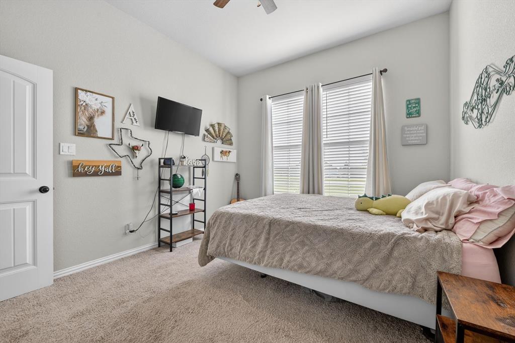 150 Chester Road Springtown, TX 76082 - Photo 17 of 40 a bedroom with a bed and a flat screen tv