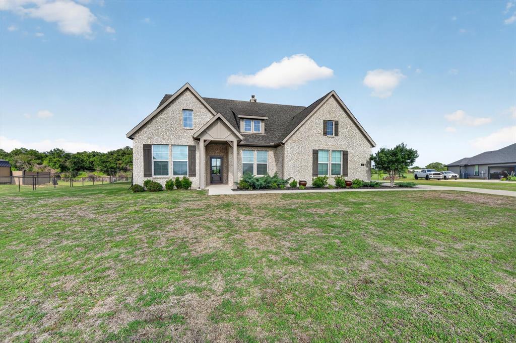 150 Chester Road Springtown, TX 76082 - Photo 2 of 40 a front view of a house with garden