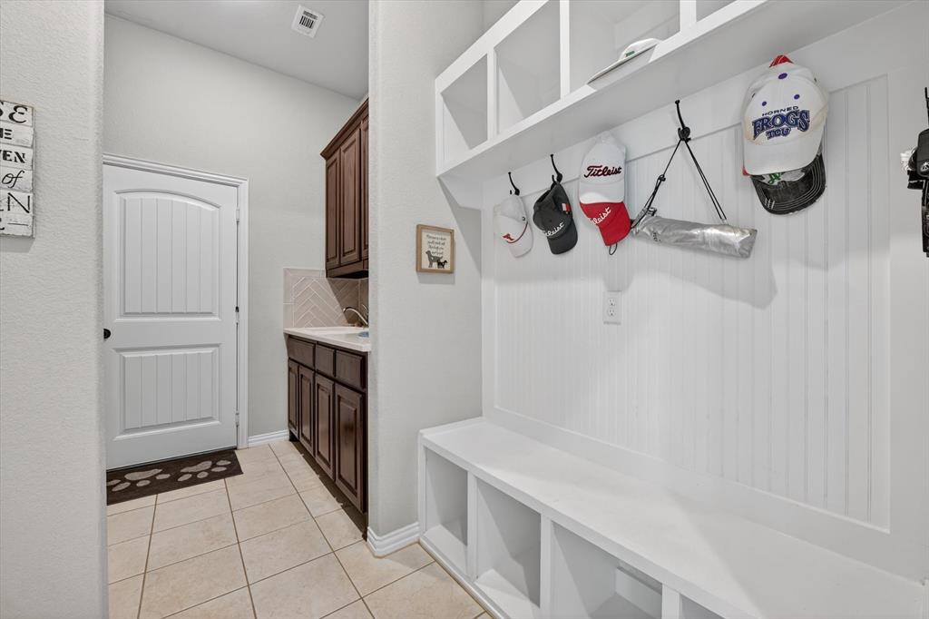 150 Chester Road Springtown, TX 76082 - Photo 22 of 40 a kitchen with a refrigerator and a sink