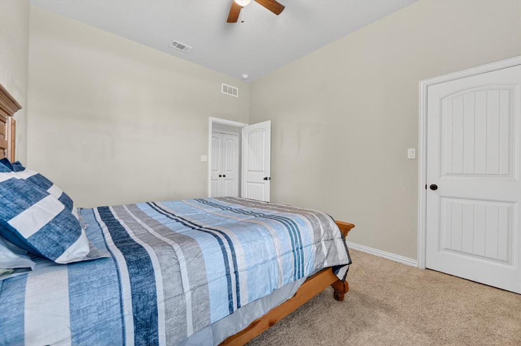 150 Chester Road Springtown, TX 76082 - Photo 26 of 40 a bedroom with a bed and a window