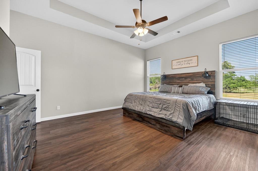 150 Chester Road Springtown, TX 76082 - Photo 30 of 40 a bedroom with a bed and a chandelier